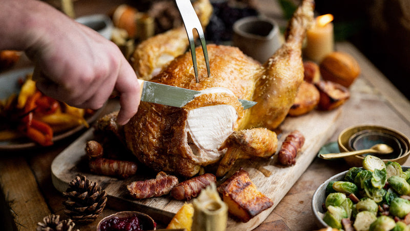 A whole cooked properly free range cockerel being sliced