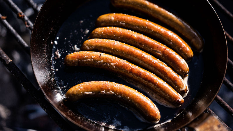 Organic Grass Fed Beef Frankfurters from Fowlescombe Rate and Pasture Ltd cooking in a pan.