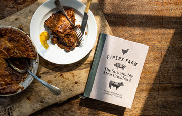 A copy of the Pipers Farm cookbook next to a meat pie