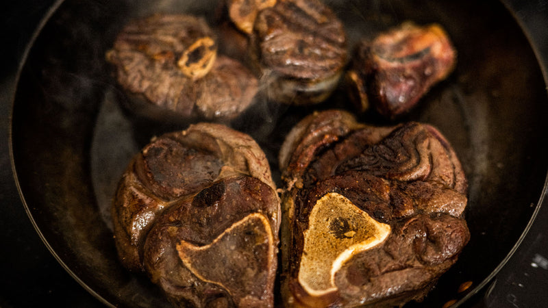 Venison Osso Bucco cooking in a pan