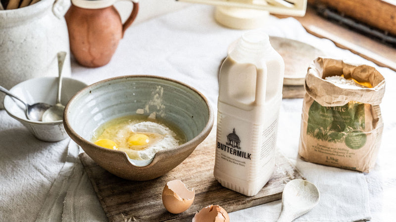 A bowl of pancake mixture ingredients including eggs, flour and raw cultured buttermilk.