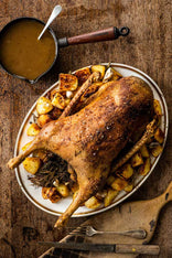 A cooked, whole properly free range goose with potatoes and gravy