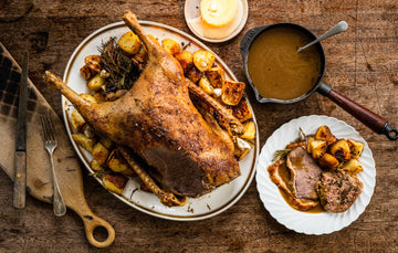 A cooked, whole properly free range goose with potatoes and gravy with potatoes and gravy