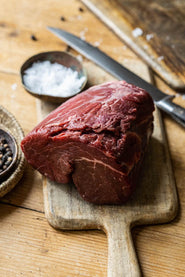 A whole, raw, Grass Fed Beef Chateaubriand sharing steak.
