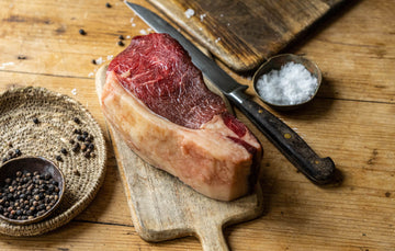 A raw, grass fed, beef sirloin sharing steak ready to be seasoned.
