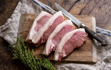 raw native breed pork loin steaks with fresh thyme
