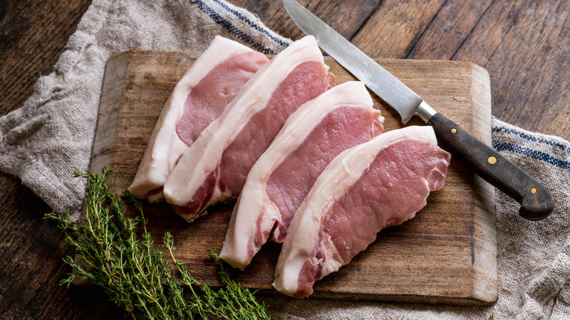 raw native breed pork loin steaks with fresh thyme