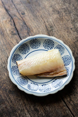 A filet of British caught smoked haddock on a plate