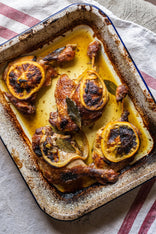 Cooked confit dug legs with sliced orange and bay leaves