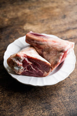 raw grass fed lamb shanks on a plate