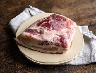 A raw native breed pigs cheek on a plate
