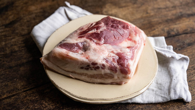 A raw native breed pigs cheek on a plate