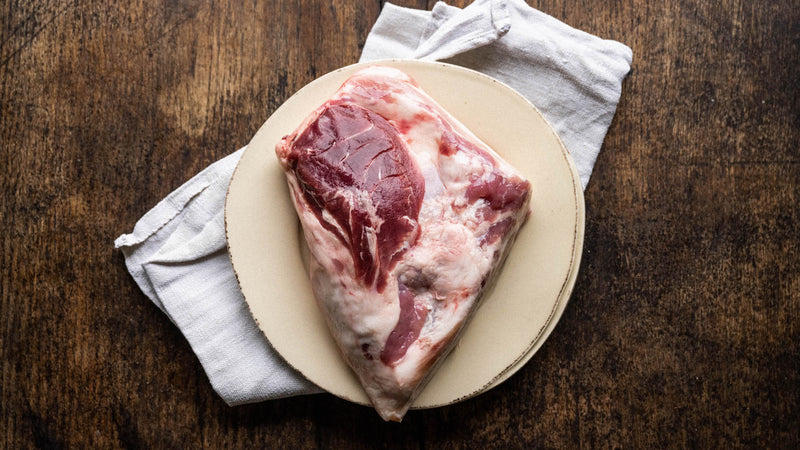 A raw native breed pigs cheek on a plate