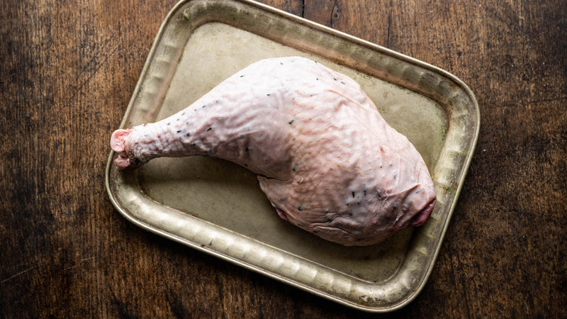 Raw free-range Bronze turkey leg for roasting or slow cooking