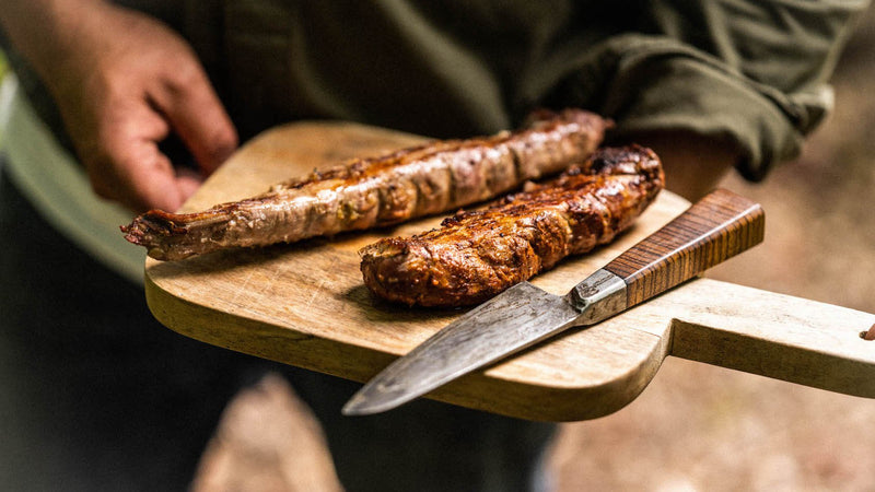Cooked native breed pork tenderloin on a chopping board