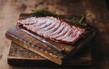 a raw rack of native breed pork ribs