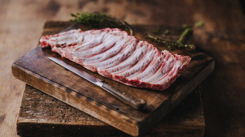 a raw rack of native breed pork ribs