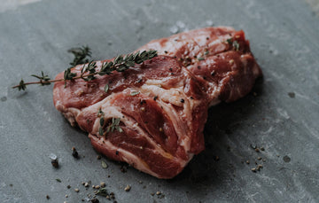 raw native breed pork steak with fresh thyme