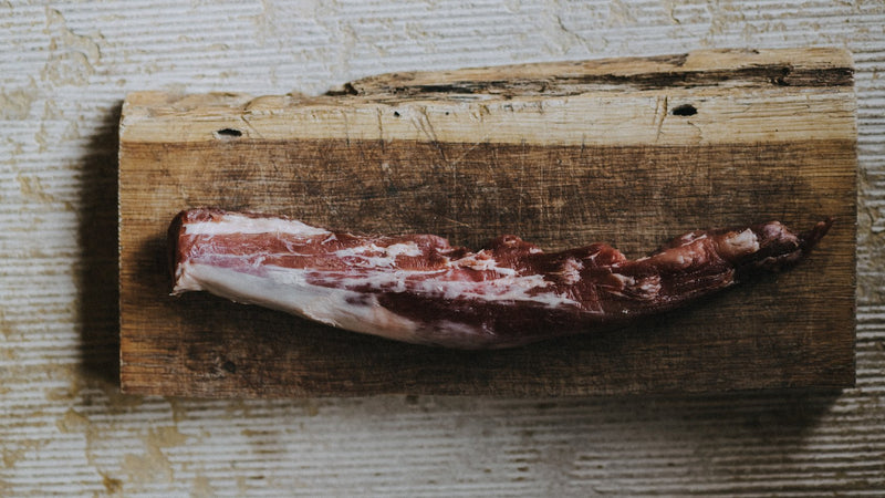 Raw native breed pork tenderloin on a chopping board