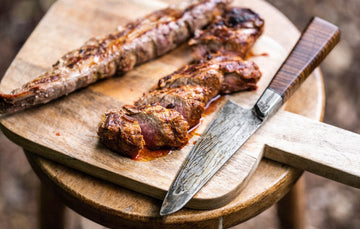 Cooked native breed pork tenderloin on a chopping board