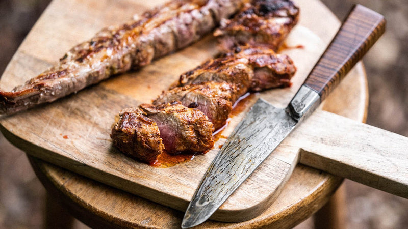 Cooked native breed pork tenderloin on a chopping board