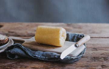 A roll of Quicke's grass fed whey butter, ready to use.