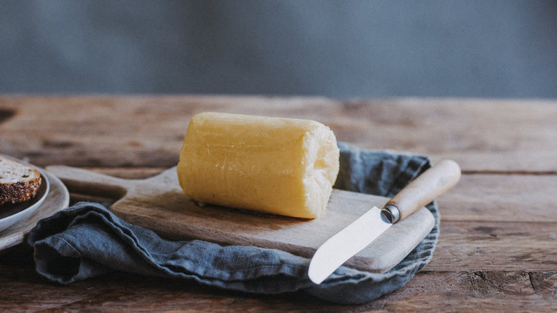 A roll of Quicke's grass fed whey butter, ready to use.