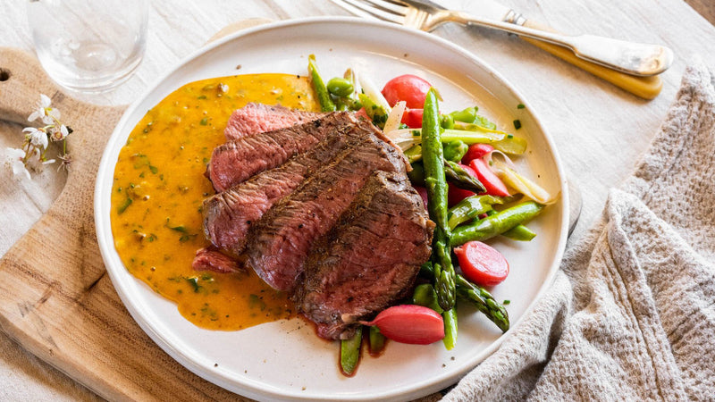 Café de Paris Hollandaise with grass fed beef ribeye steak and spring vegetables.