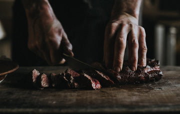 Slicing cooked grass fed beef rump tail