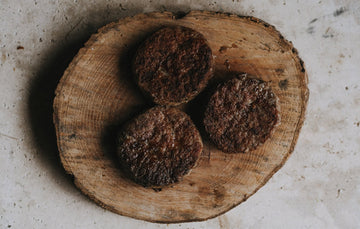 Cooked grass fed beef steak burgers.