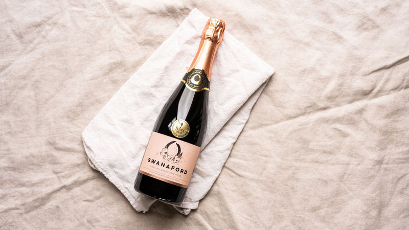 A bottle of Swanaford Brut Rosé sparkling pink wine.