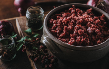 Raw Wild Venison Mince Meat with blackberries, onions, and peppercorns.