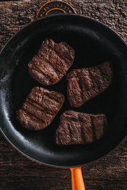 Wild venison steaks cooking in a pan